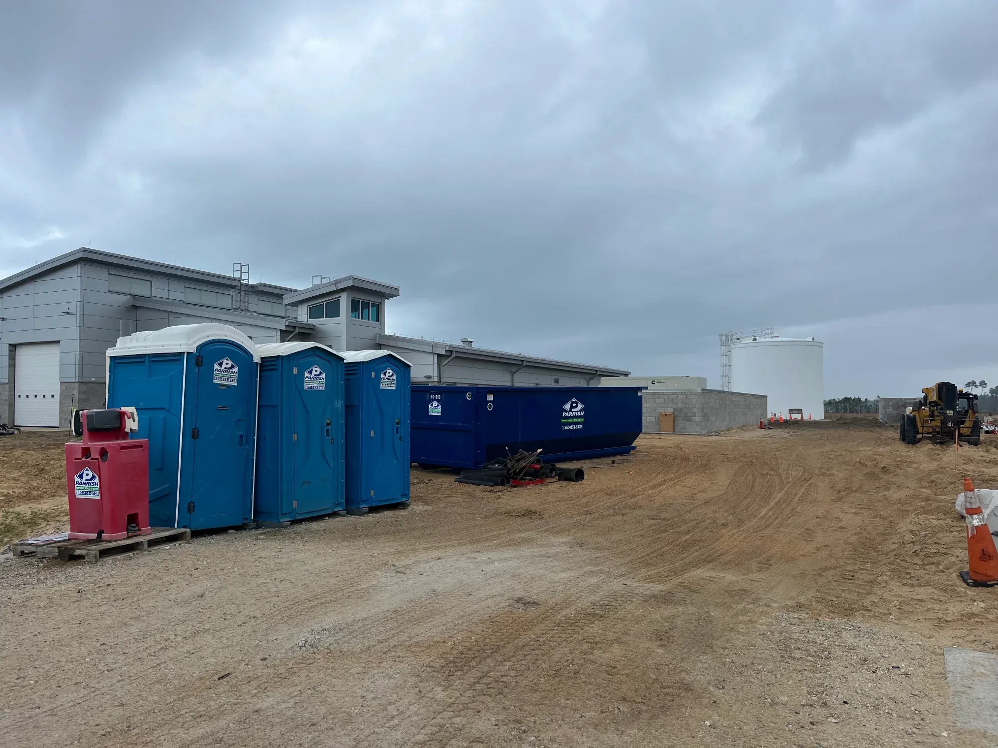Parrish porta potties and a handwash station on an active construction site
