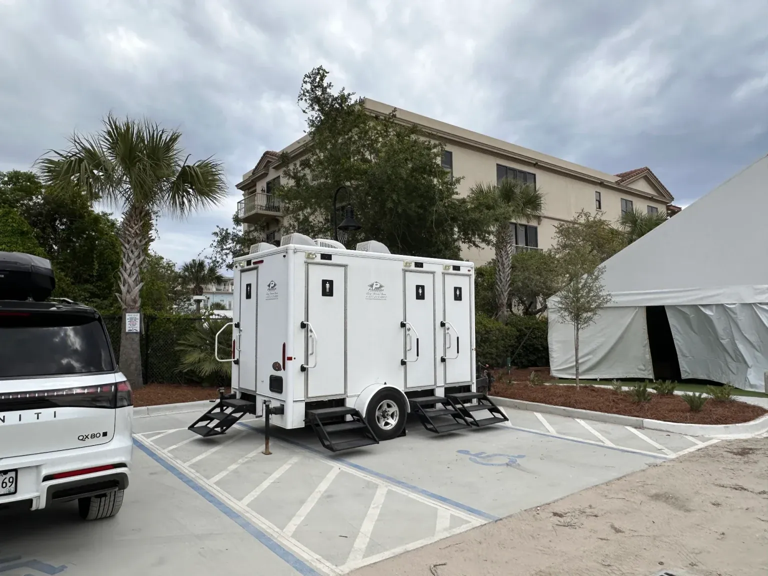 Parrish luxury restroom trailer set up beside a tented event